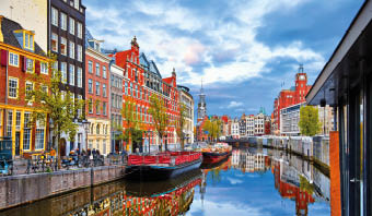 Channel in Amsterdam Netherlands houses river Amstel landmark old european city spring landscape.