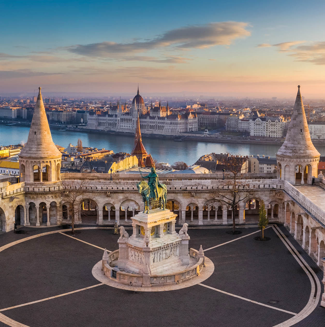 Budapest, Hungary - The famous Fisherman's Bastion at sunrise with statue of King Stephen I and Parliament of Hungary at background