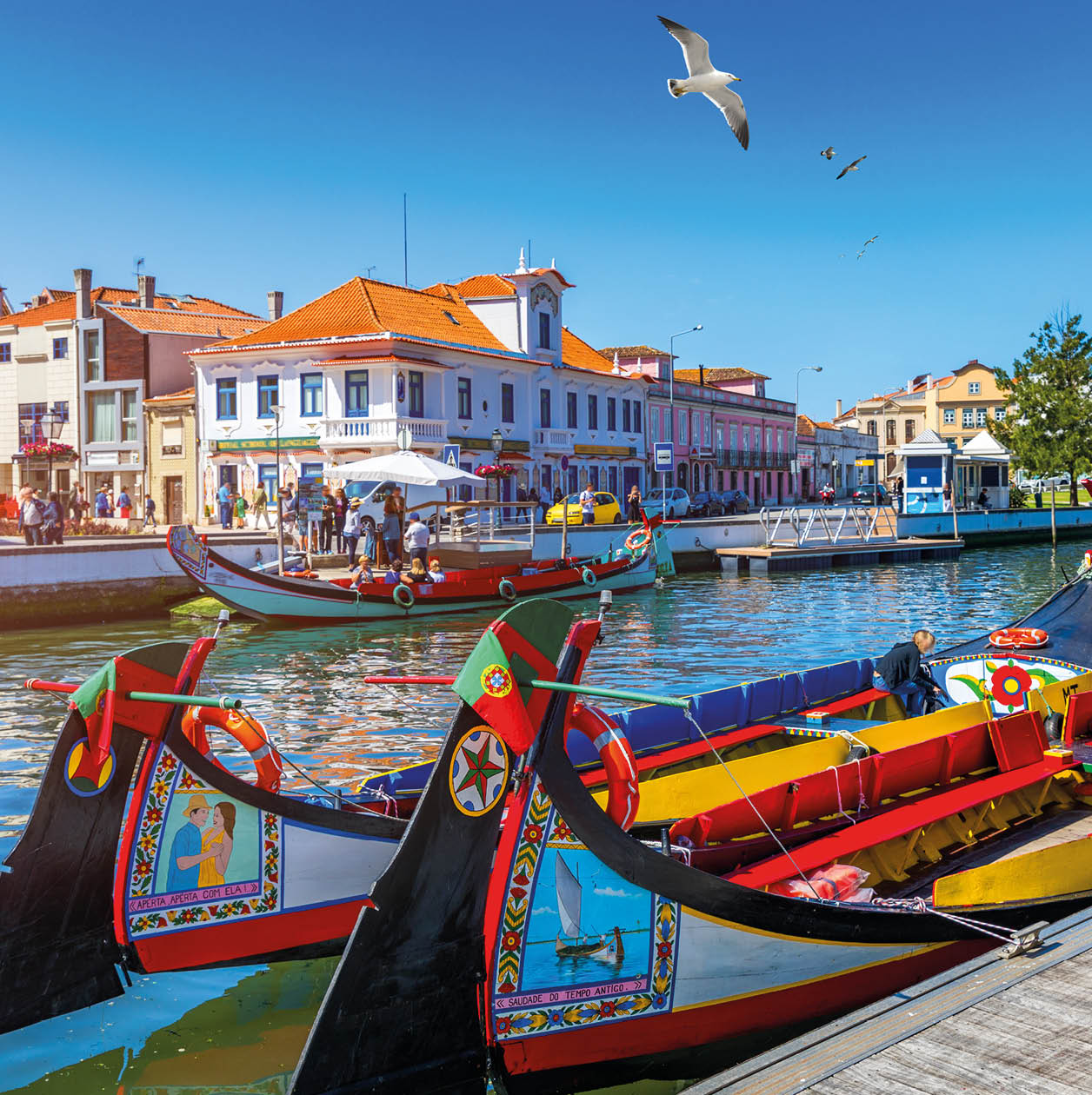 Traditional boats on the canal in Aveiro, Portugal. Colorful Moliceiro boat rides in Aveiro are popular with tourists to enjoy views of the charming canals. Aveiro, Portugal. 