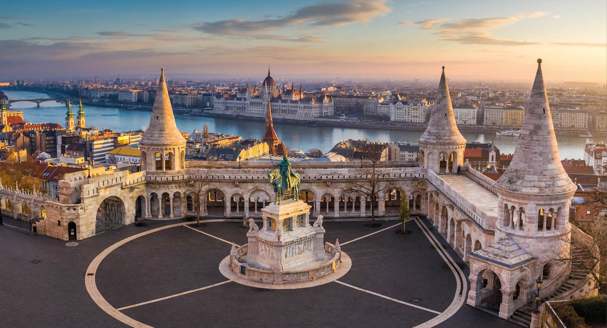 Budapest, Hungary - The famous Fisherman's Bastion at sunrise with statue of King Stephen I and Parliament of Hungary at background