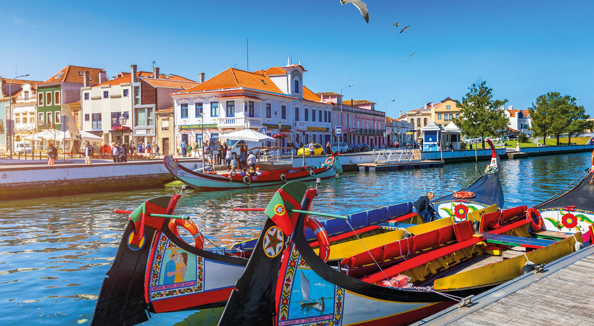 Traditional boats on the canal in Aveiro, Portugal. Colorful Moliceiro boat rides in Aveiro are popular with tourists to enjoy views of the charming canals. Aveiro, Portugal. 