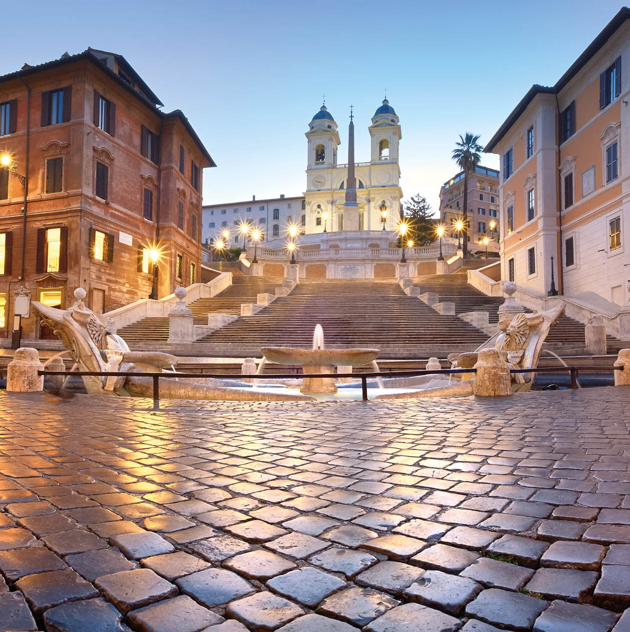 Spanish Steps and a boat-shaped fountain on Piazza di Spagna in Rome, Italy. Early morning panoramic shot after rain.