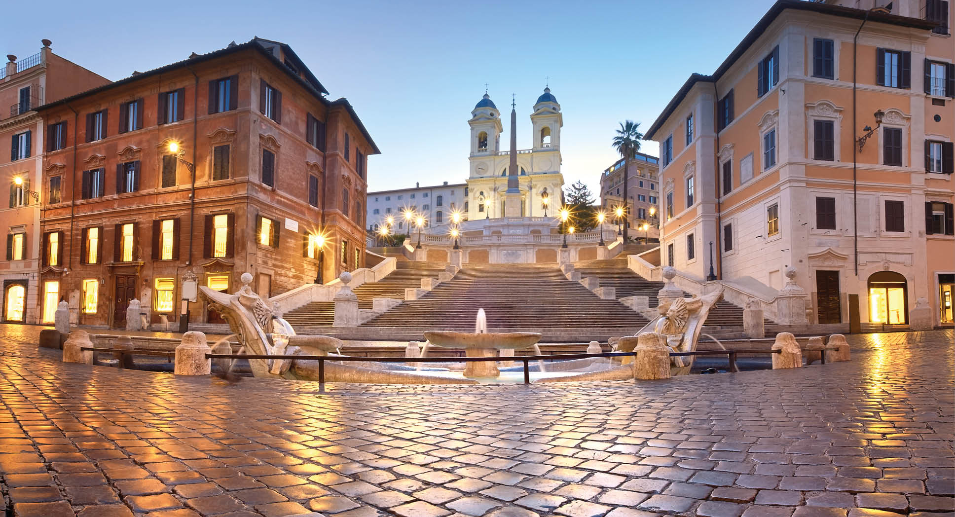Spanish Steps and a boat-shaped fountain on Piazza di Spagna in Rome, Italy. Early morning panoramic shot after rain.