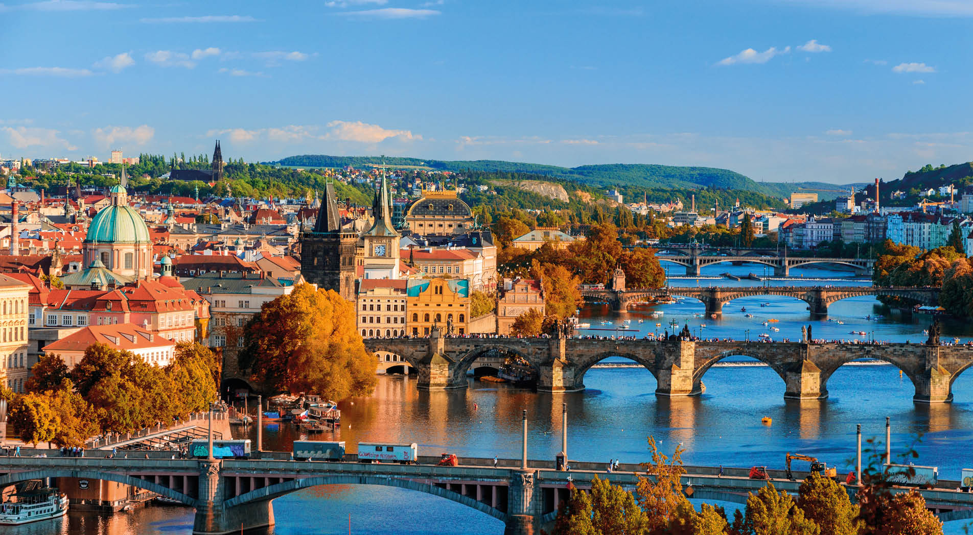 View of the Vltava River and Charle bridge with red foliage, Prague, Czech Republic