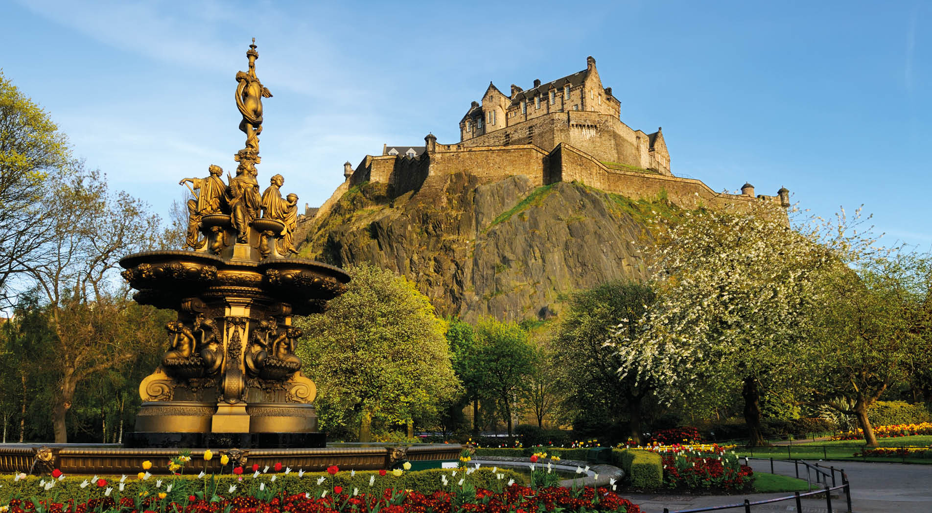 A view of the iconic Edinburgh Castle, looking up from Princess Street gardens with the Ross fountain in the foreground. XL image size.