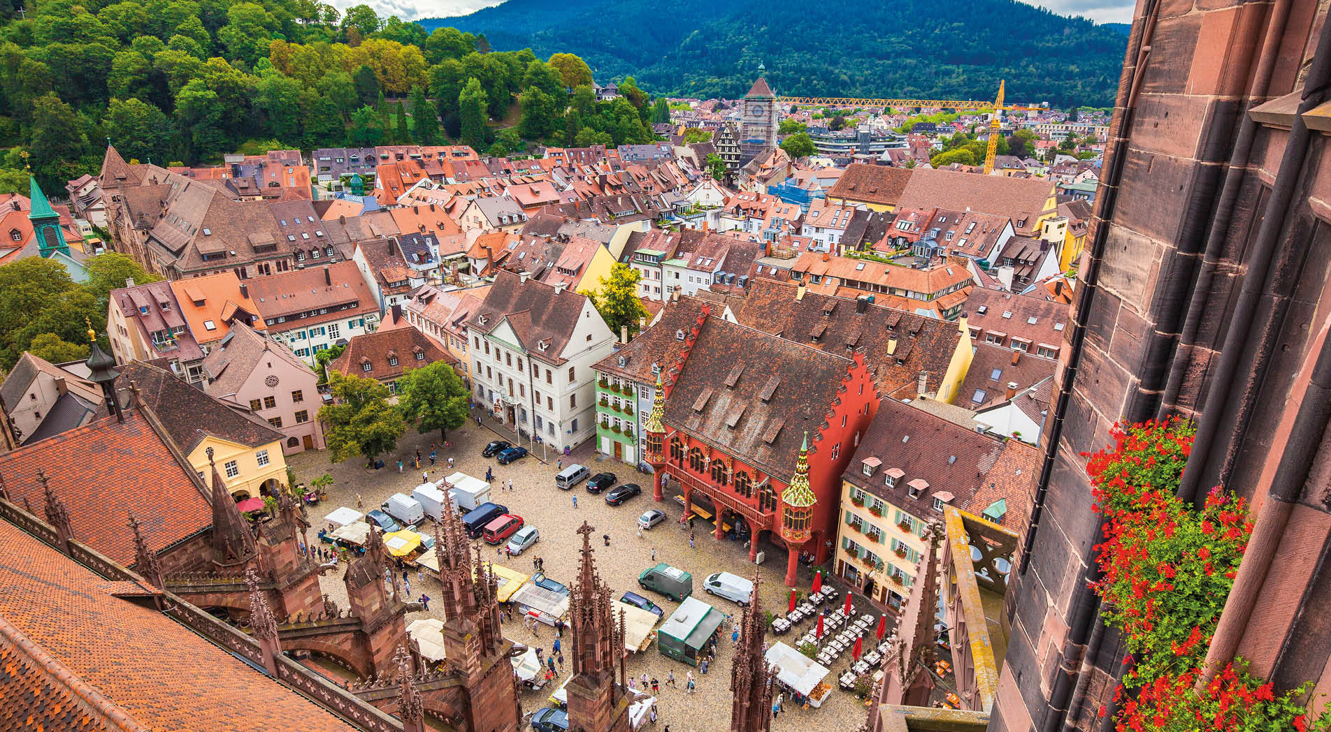 Aerial view of the historic city center of Freiburg im Breisgau from famous Freiburger Minster in beautiful evening light at sunset with blue sky and clouds in summer, Baden-Wurttemberg, Germany