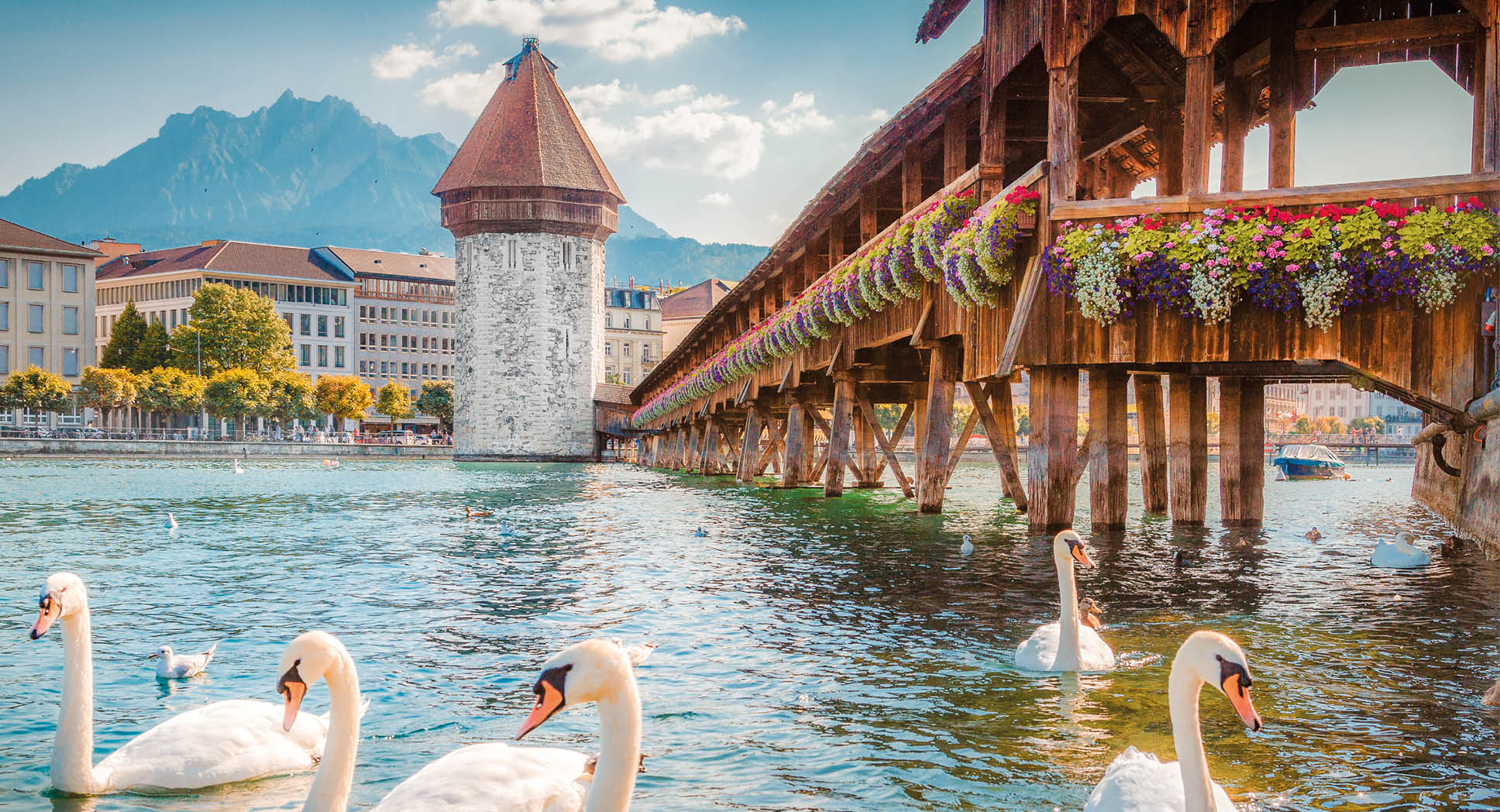 Historic city center of Lucerne with famous Chapel Bridge, the city's symbol and one of the Switzerland's main tourist attractions, and Mount Pilatus peak in the background, Switzerland