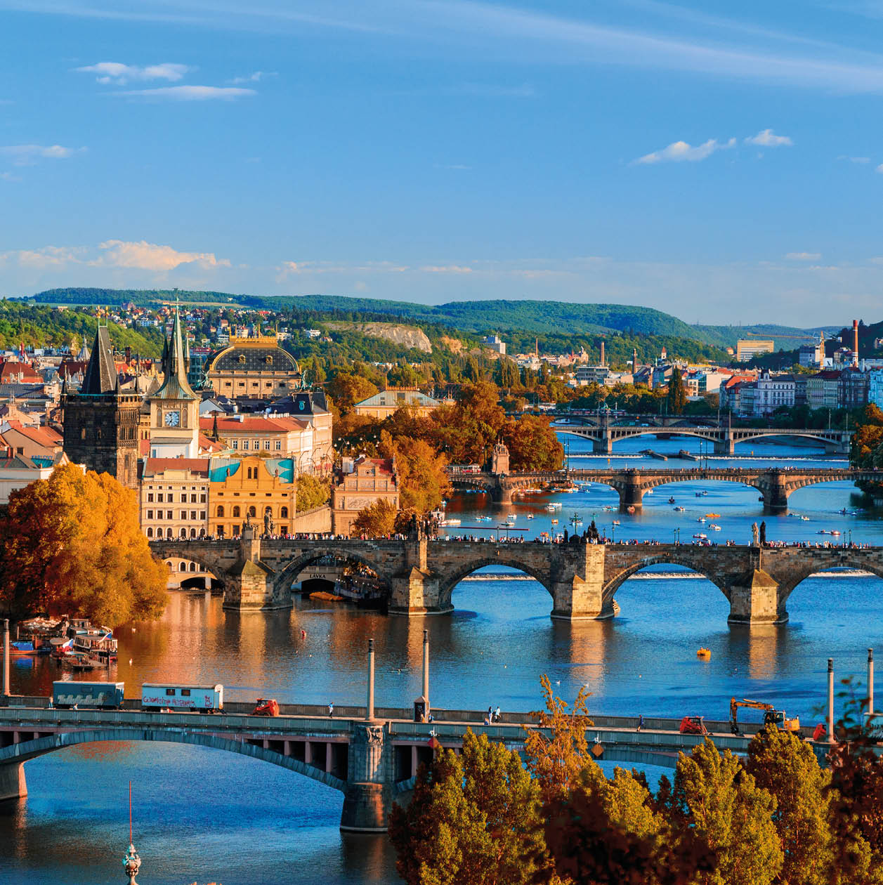 View of the Vltava River and Charle bridge with red foliage, Prague, Czech Republic