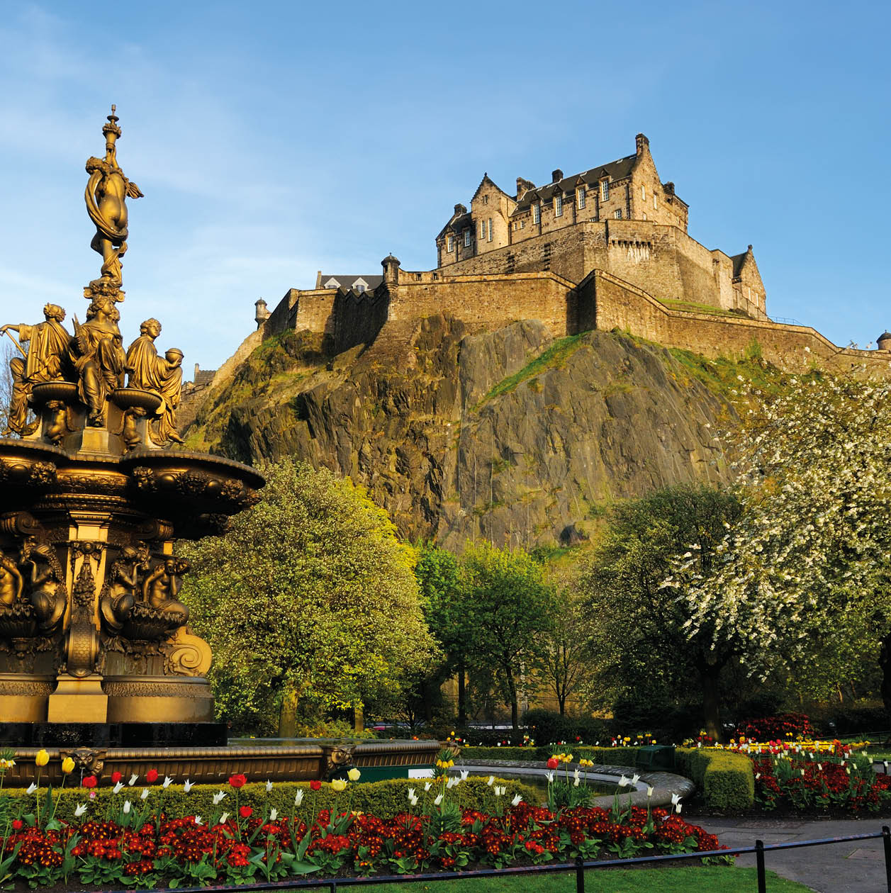 A view of the iconic Edinburgh Castle, looking up from Princess Street gardens with the Ross fountain in the foreground. XL image size.