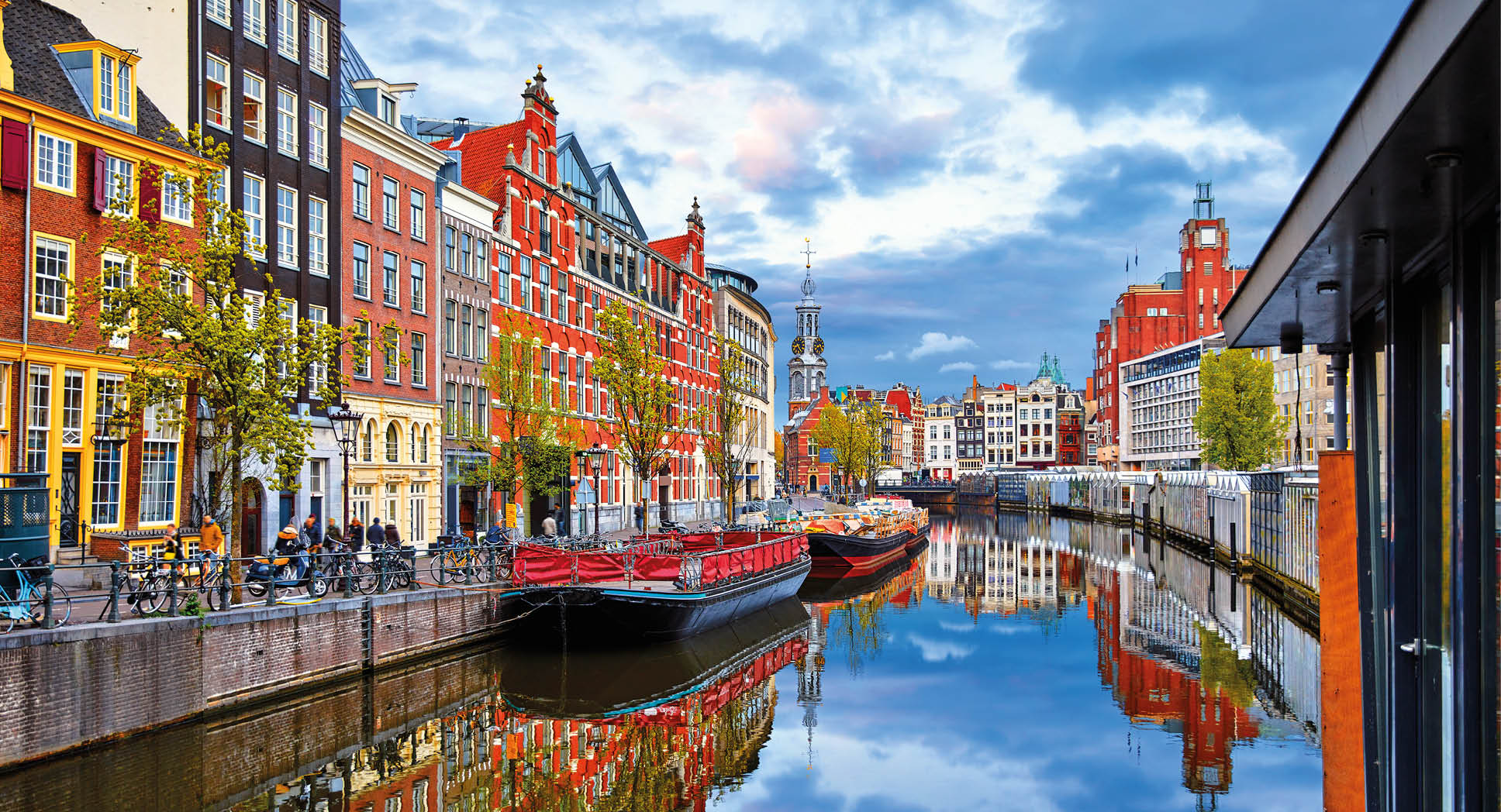 Channel in Amsterdam Netherlands houses river Amstel landmark old european city spring landscape.
