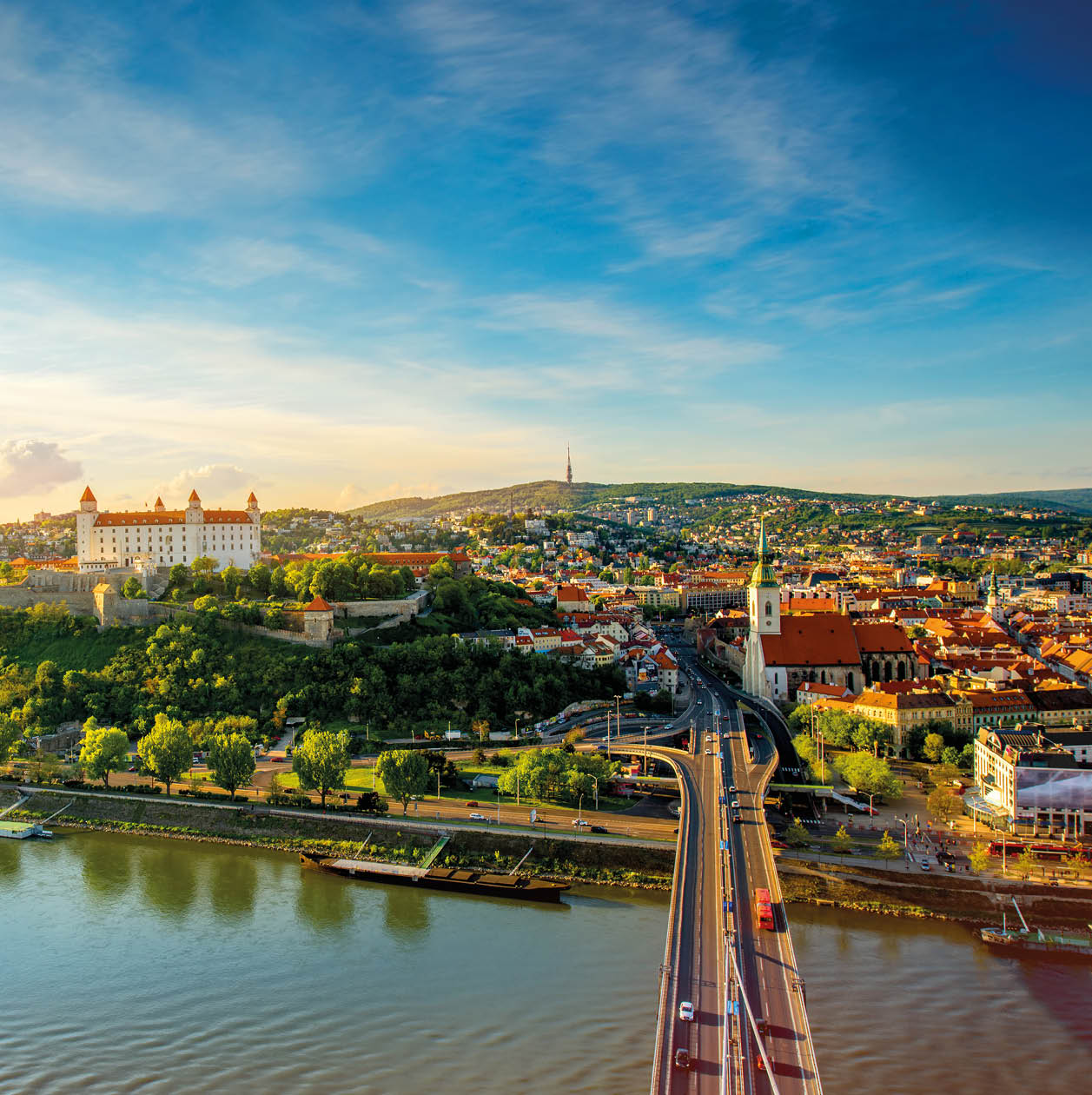 Bratislava aerial cityscape view on the old town with Saint Martin's cathedral, castle hill and Danube river on the sunset in Slovakia. Wide angle view with copy space