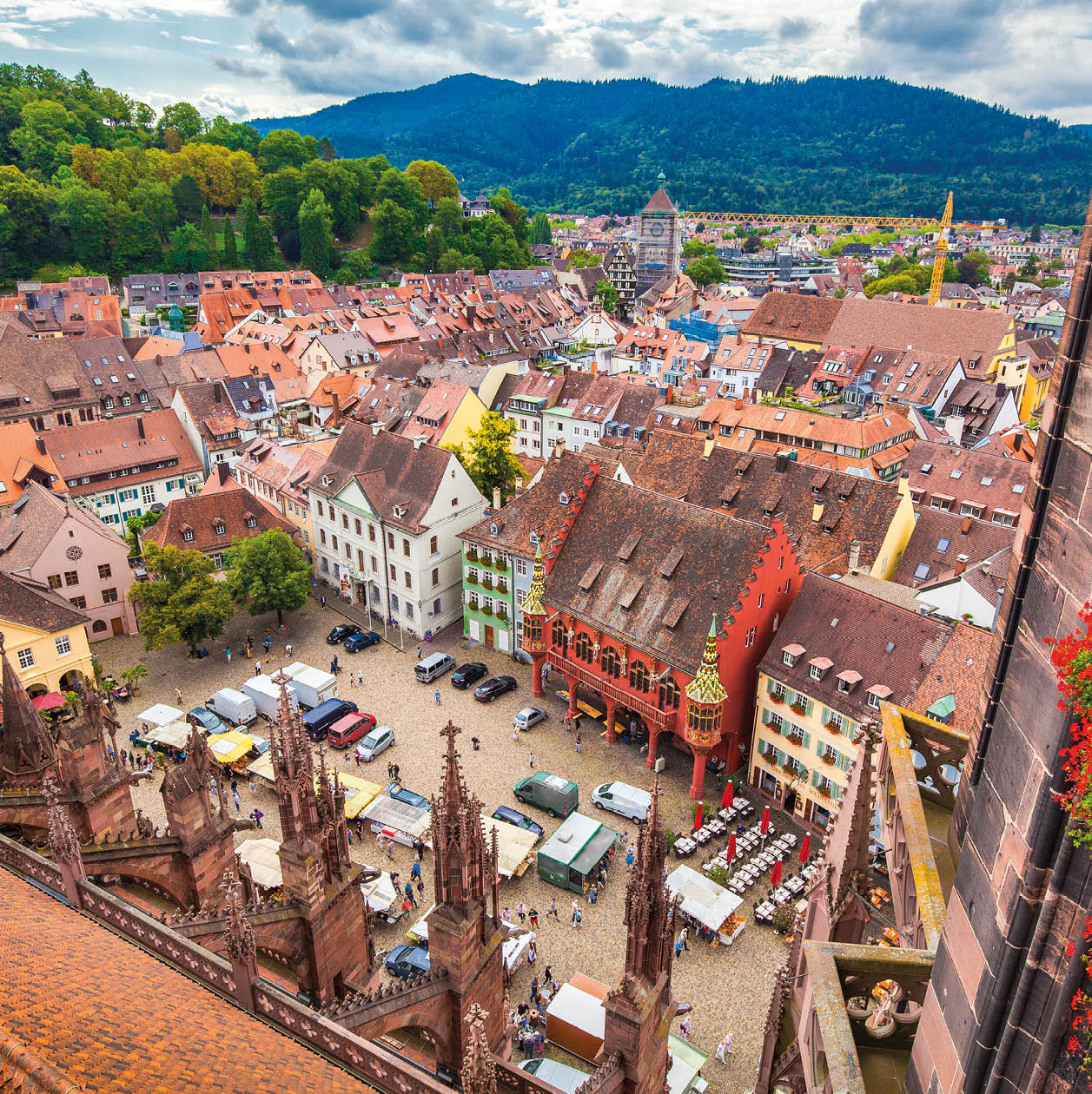 Aerial view of the historic city center of Freiburg im Breisgau from famous Freiburger Minster in beautiful evening light at sunset with blue sky and clouds in summer, Baden-Wurttemberg, Germany
