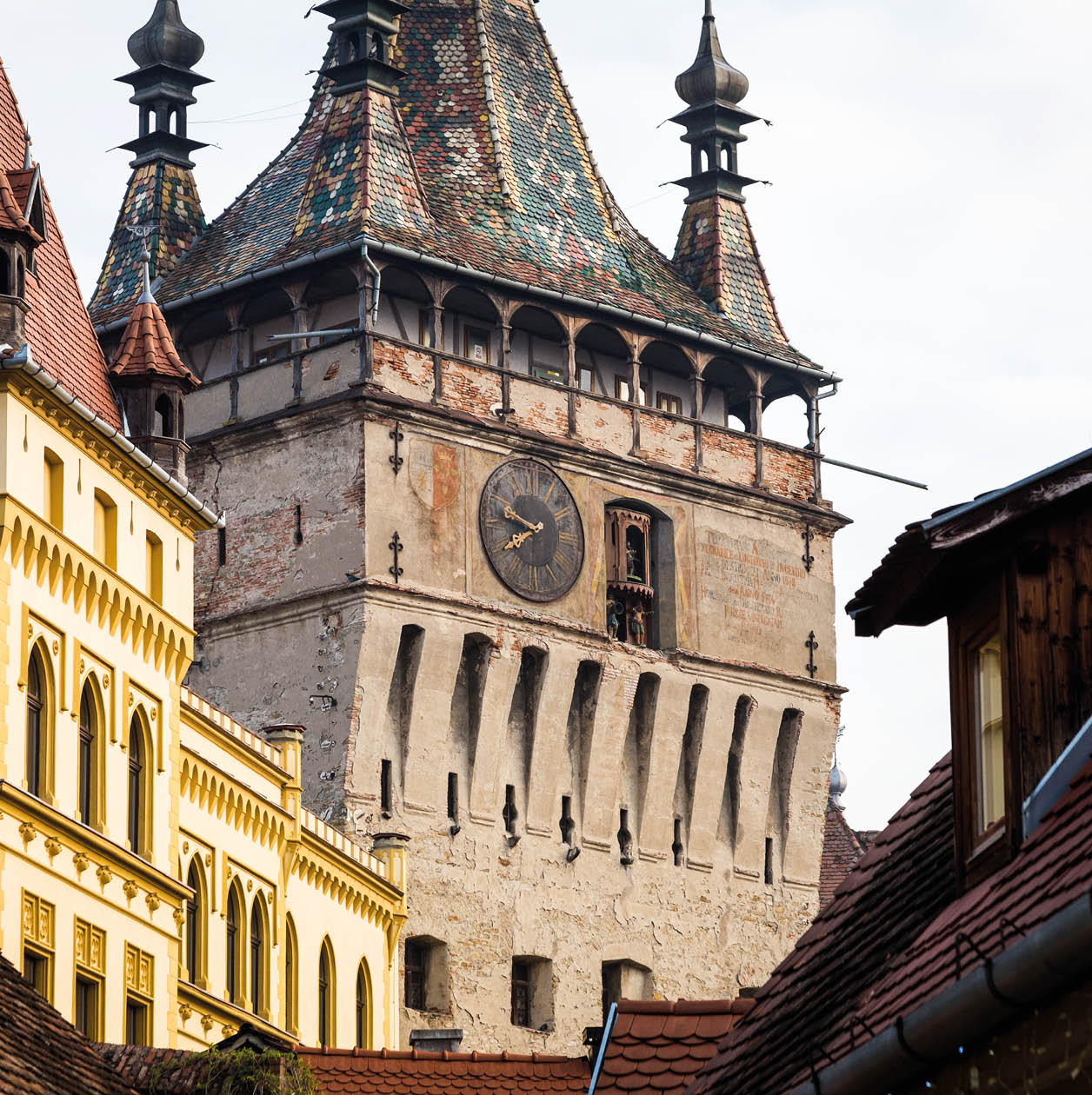 Old houses on a narrow street in the old town of Sighisoara, a small, historic town in the Transylvania region of Romania. Up ahead, at the end of the street, is an old church and clock tower in this truly ancient town that is the birthplace of Vlad Tepes, also known as Vlad the Impaler. Horizontal colour image with copy space.