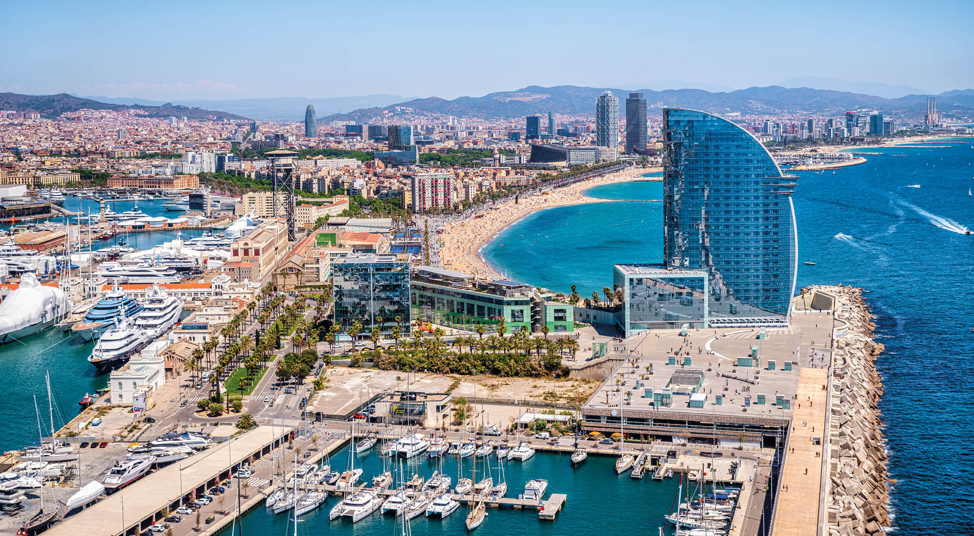 Front of Barcelona from the air with the port vell, the business center and the hotel