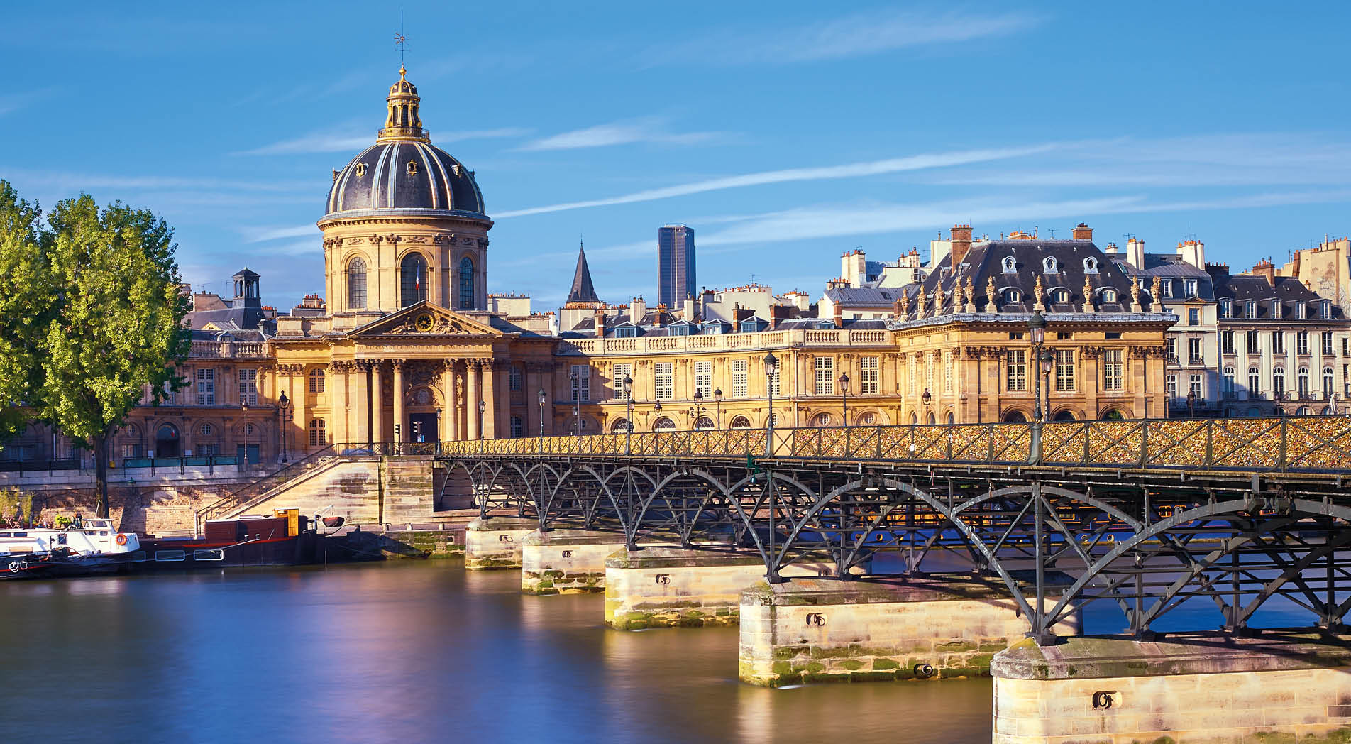 Pont des Arts leading towards Institut de France, Paris, France. The bridge is a popular place for couples in Europe.