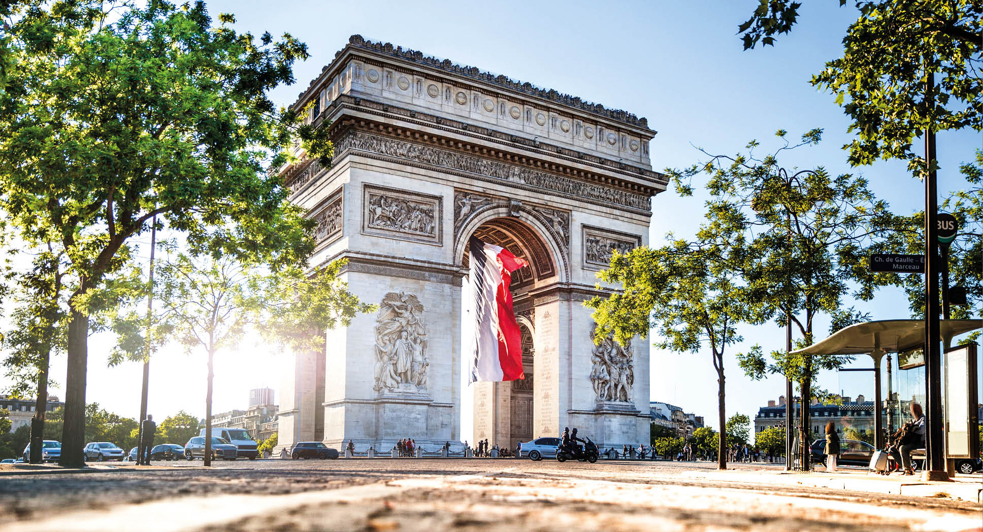 View of Paris Arc de Triomphe at night during the 14th of July, National Holiday.