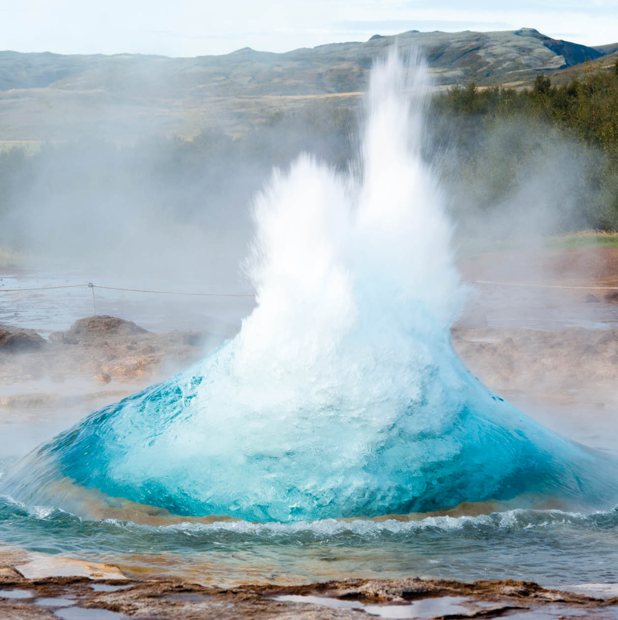 detail shot of hot spring strokkur on iceland in the first second of eruption; geothermal region in the golden circle (Gullfoss, Thingvellir, Geysir) of iceland