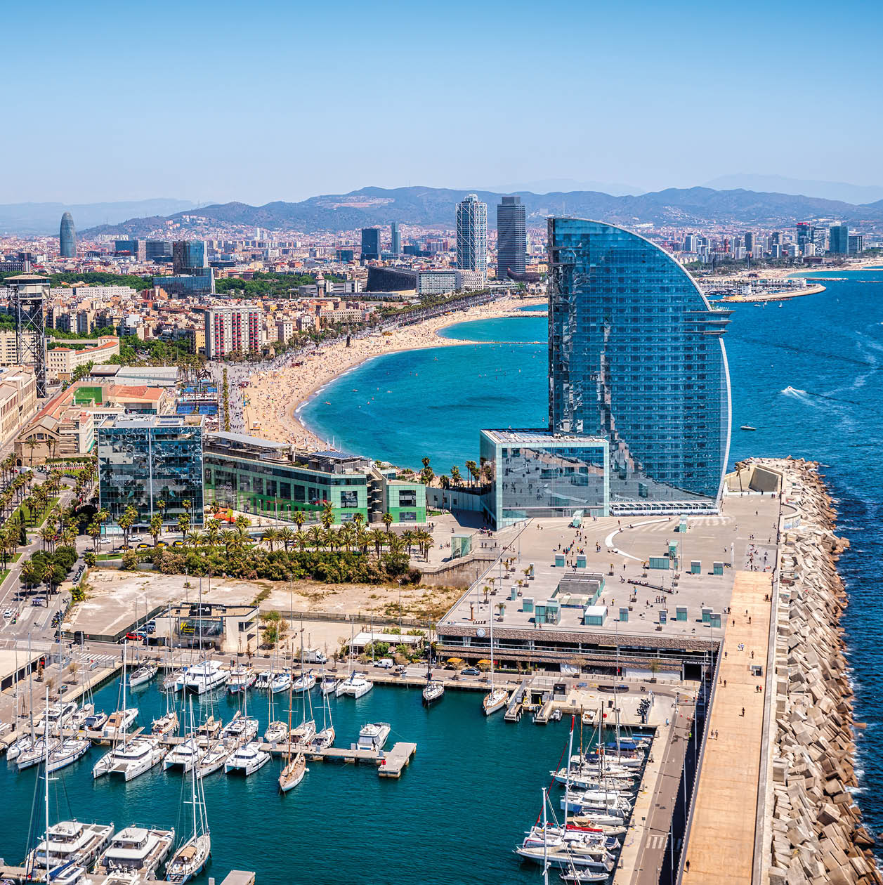 Front of Barcelona from the air with the port vell, the business center and the hotel