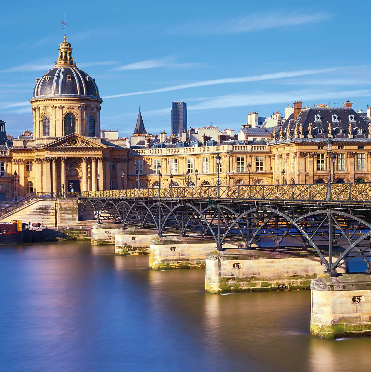 Pont des Arts leading towards Institut de France, Paris, France. The bridge is a popular place for couples in Europe.