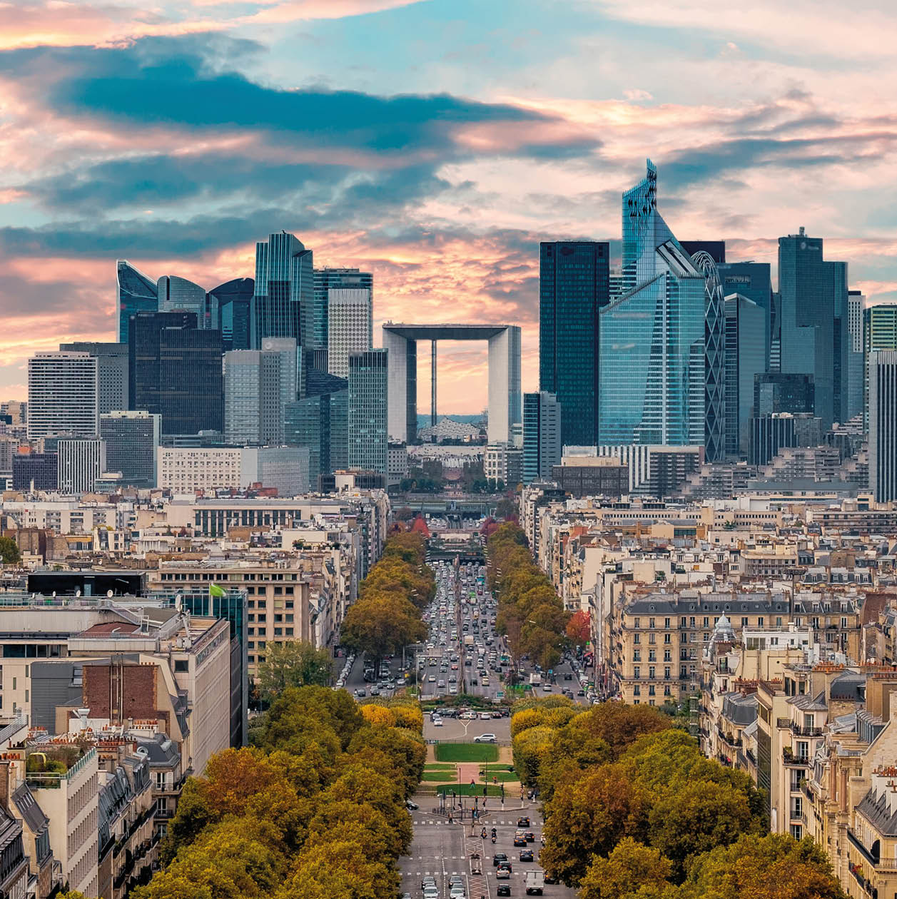 La Defense Financial District Paris France in autumn. Traffic on Champs-Elysees with orange and yellow trees aside. Modern vs. Old architecture