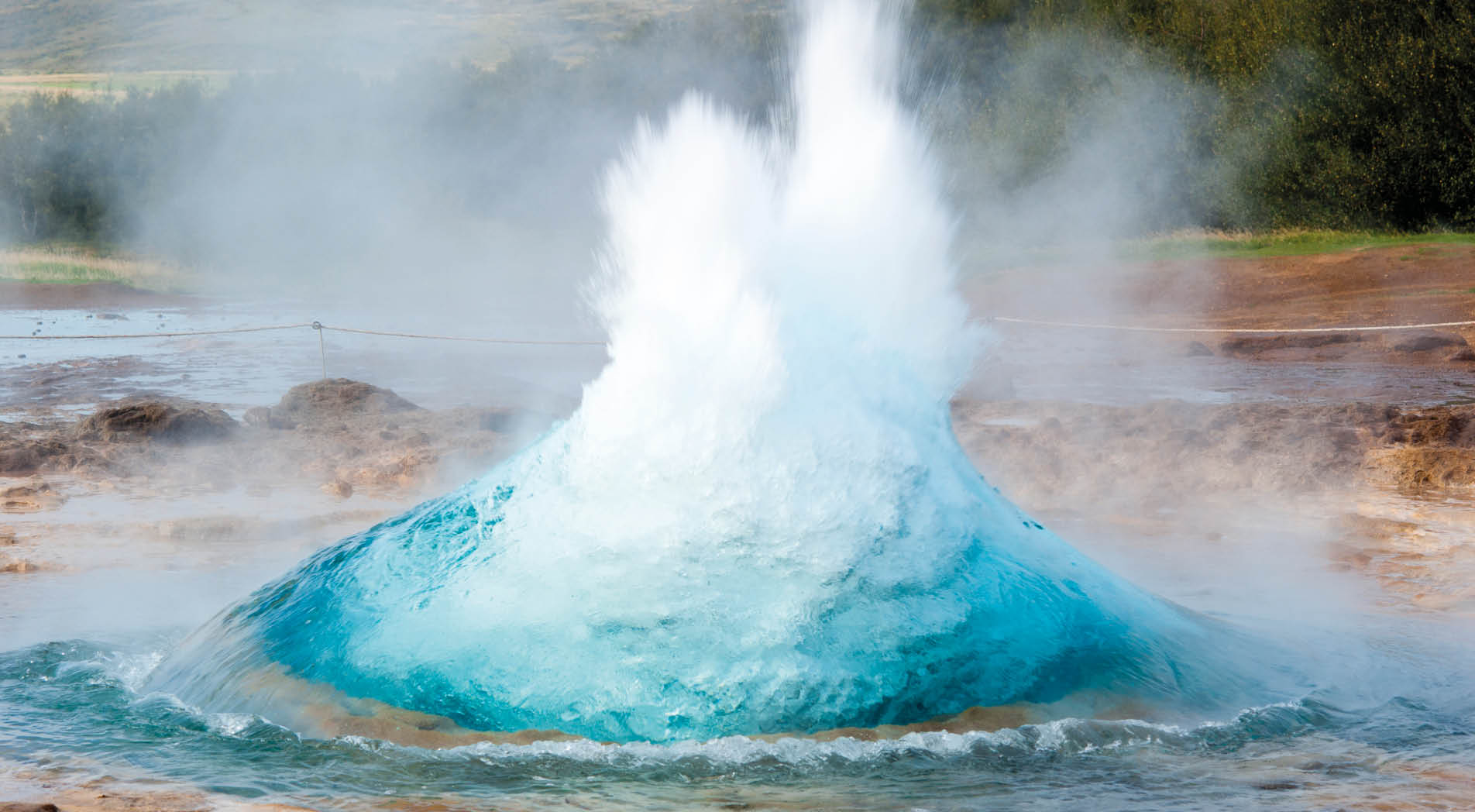 detail shot of hot spring strokkur on iceland in the first second of eruption; geothermal region in the golden circle (Gullfoss, Thingvellir, Geysir) of iceland