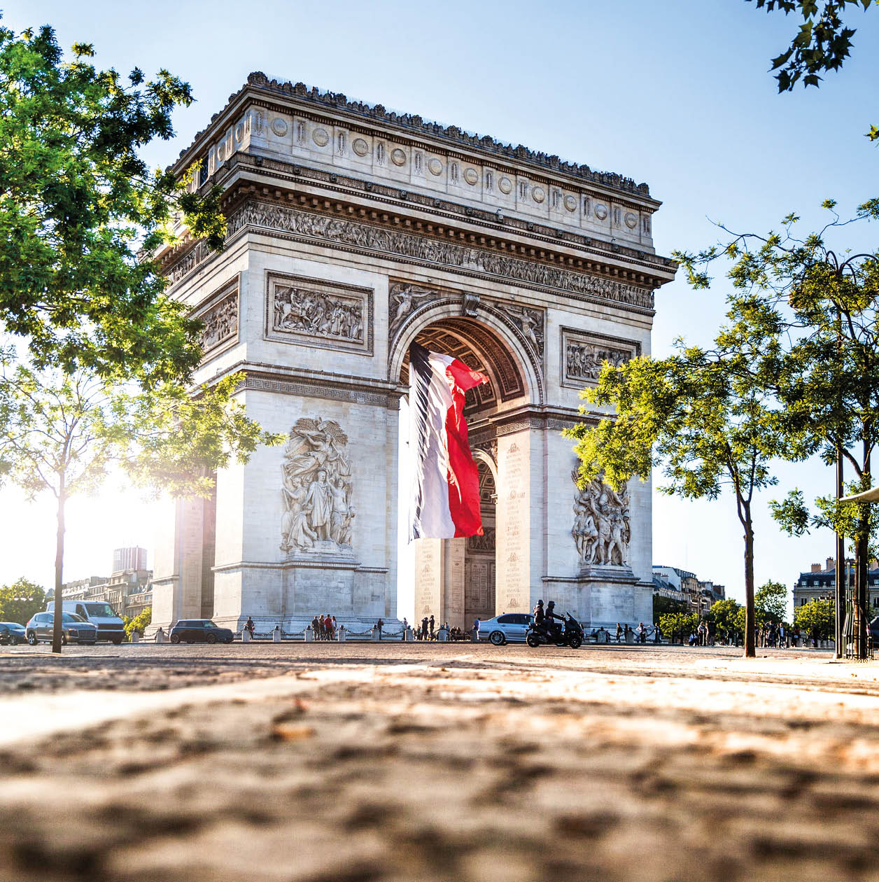 View of Paris Arc de Triomphe at night during the 14th of July, National Holiday.