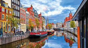 Channel in Amsterdam Netherlands houses river Amstel landmark old european city spring landscape.