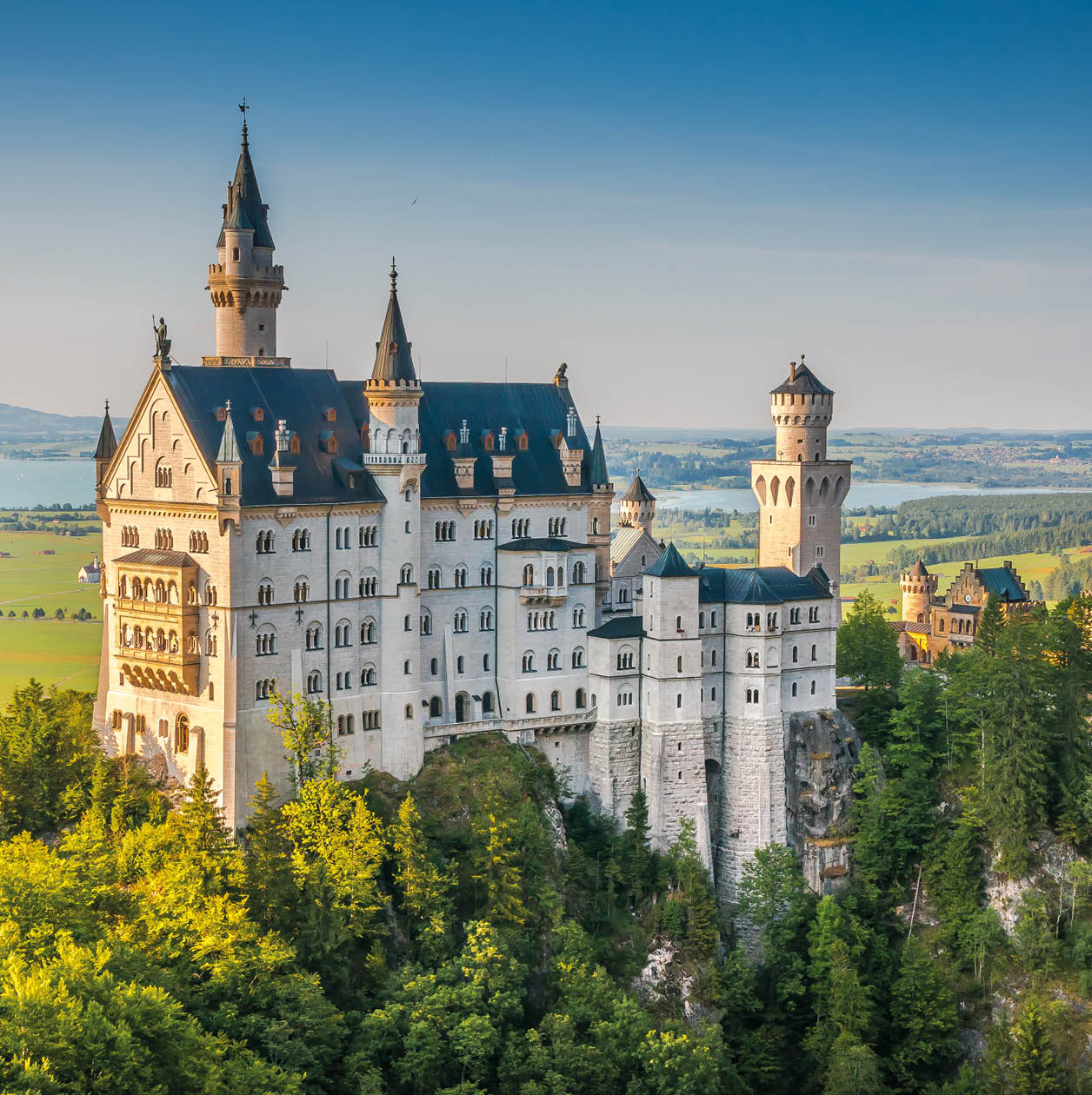 Beautiful view of world-famous Neuschwanstein Castle, the 19th century Romanesque Revival palace built for King Ludwig II, in beautiful evening light at sunset, Fussen, southwest Bavaria, Germany
