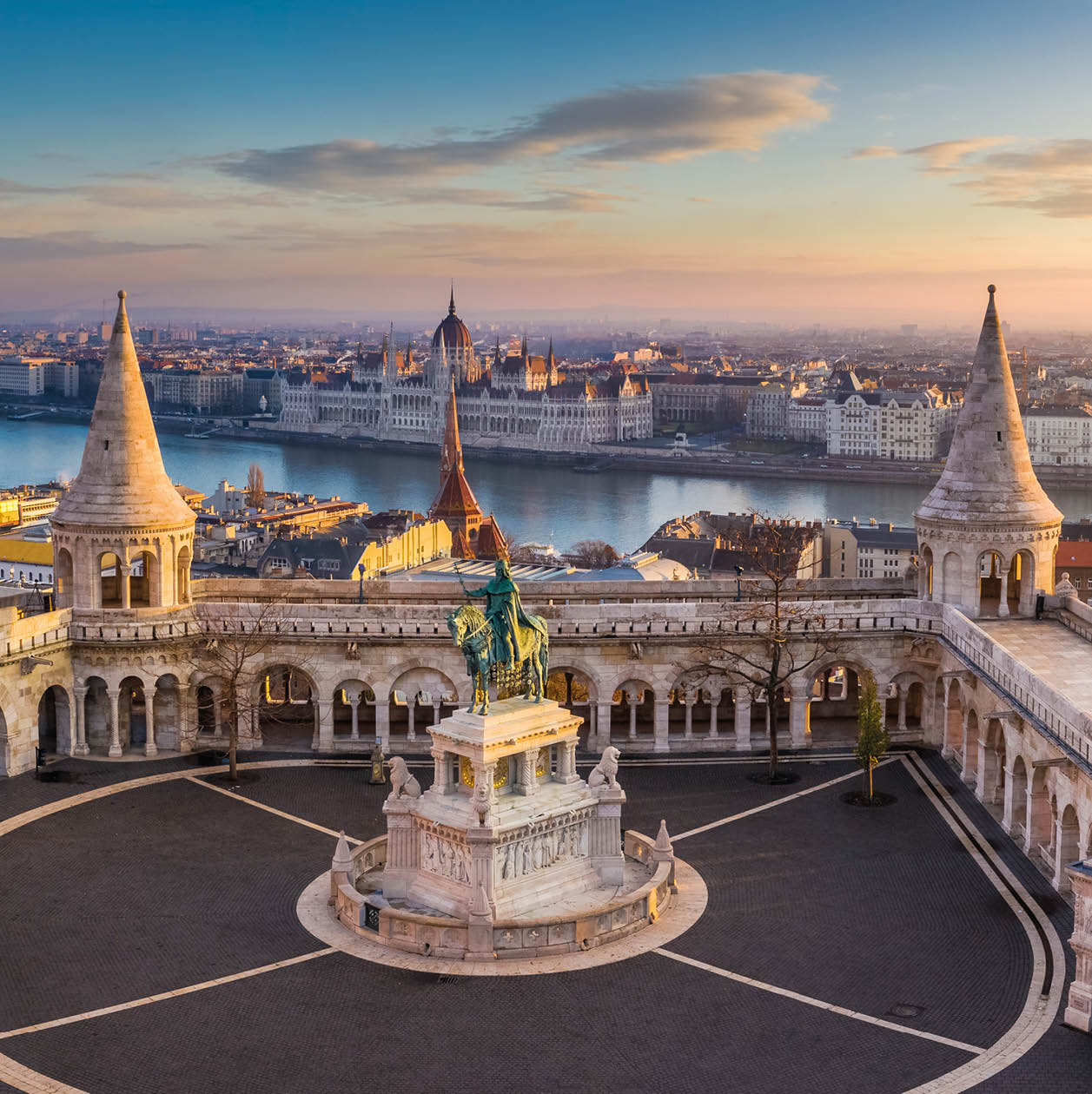 Budapest, Hungary - The famous Fisherman's Bastion at sunrise with statue of King Stephen I and Parliament of Hungary at background