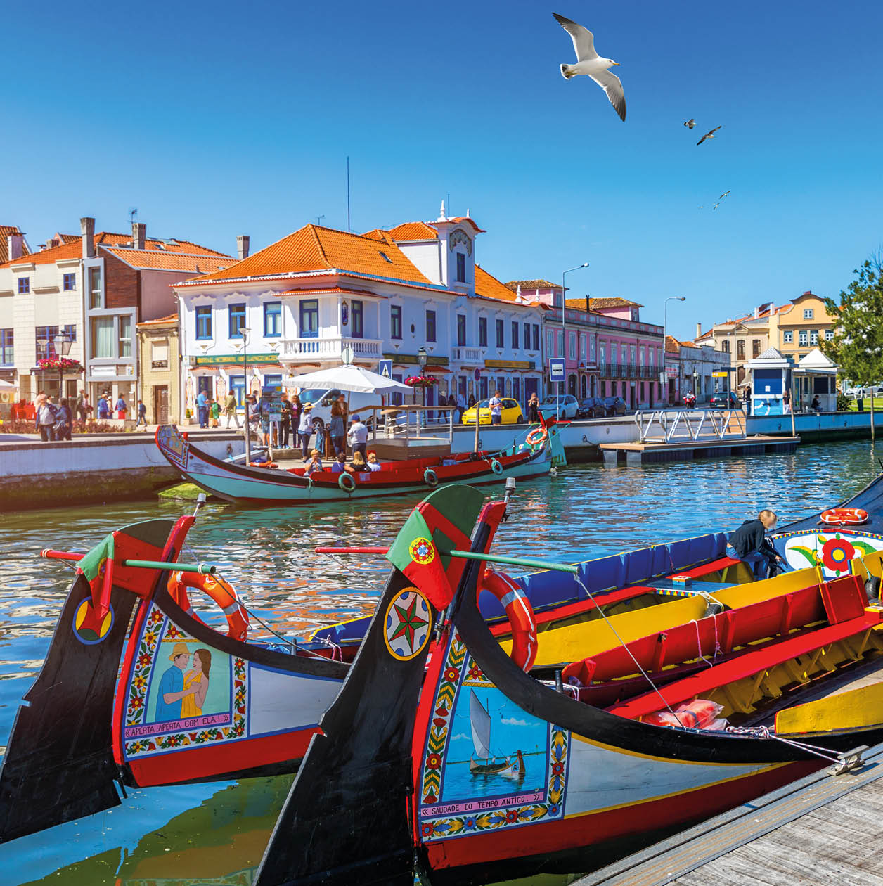 Traditional boats on the canal in Aveiro, Portugal. Colorful Moliceiro boat rides in Aveiro are popular with tourists to enjoy views of the charming canals. Aveiro, Portugal. 