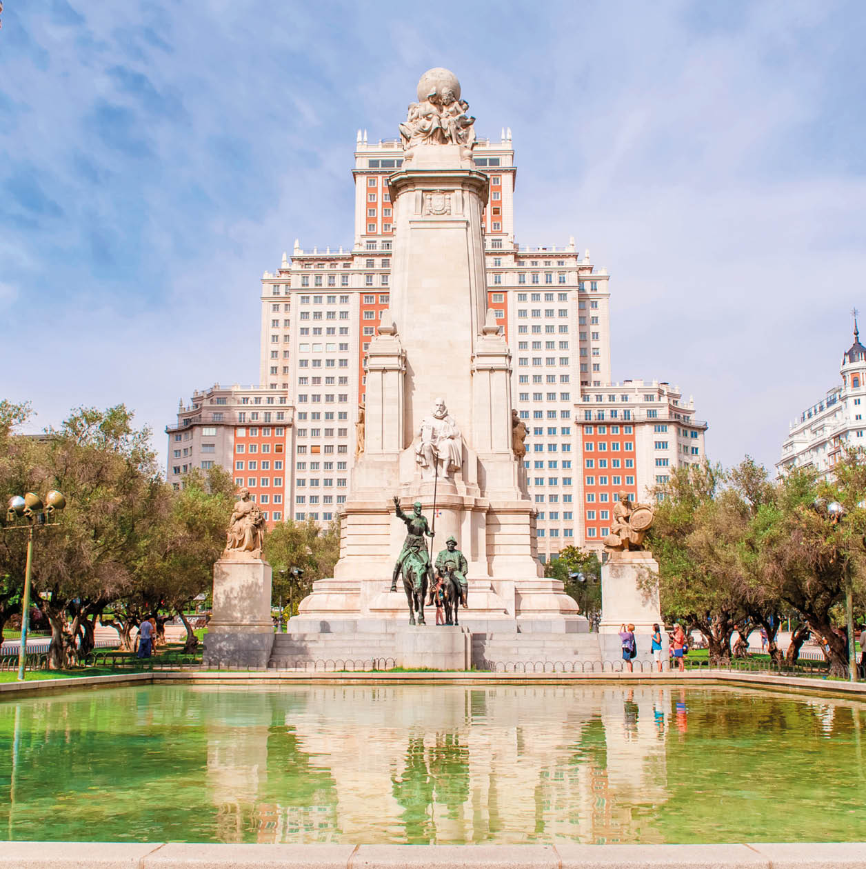 MADRID SPAIN - JUNE 23, 2015: The Cervantes monument, the Tower of Madrid (Torre de Madrid) and the Spain Building (Edificio Espana) on the Square of Spain (Plaza de Espana).