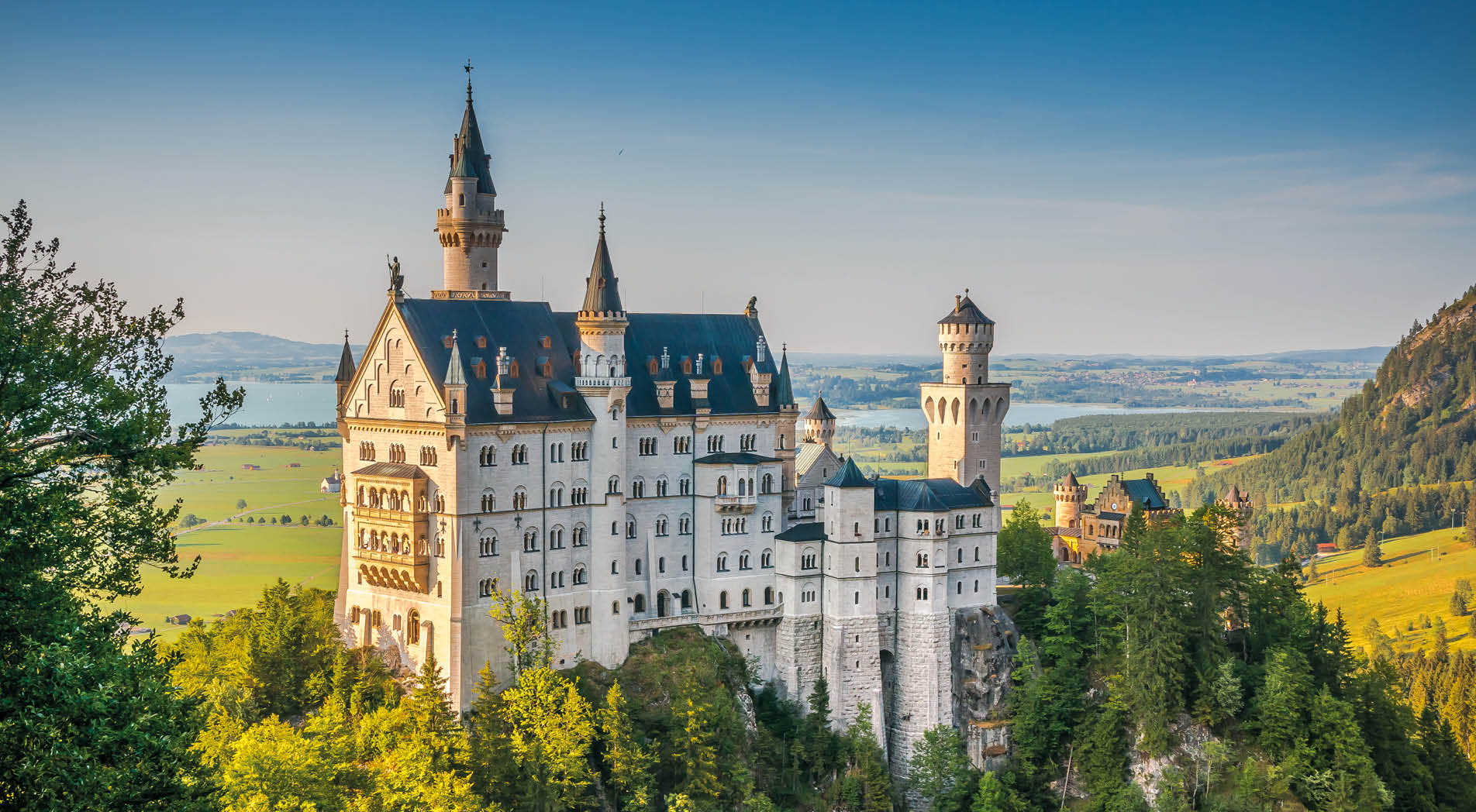 Beautiful view of world-famous Neuschwanstein Castle, the 19th century Romanesque Revival palace built for King Ludwig II, in beautiful evening light at sunset, Fussen, southwest Bavaria, Germany