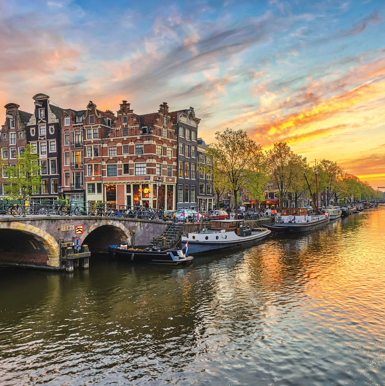 Amsterdam sunset city skyline at canal waterfront, Amsterdam, Netherlands
