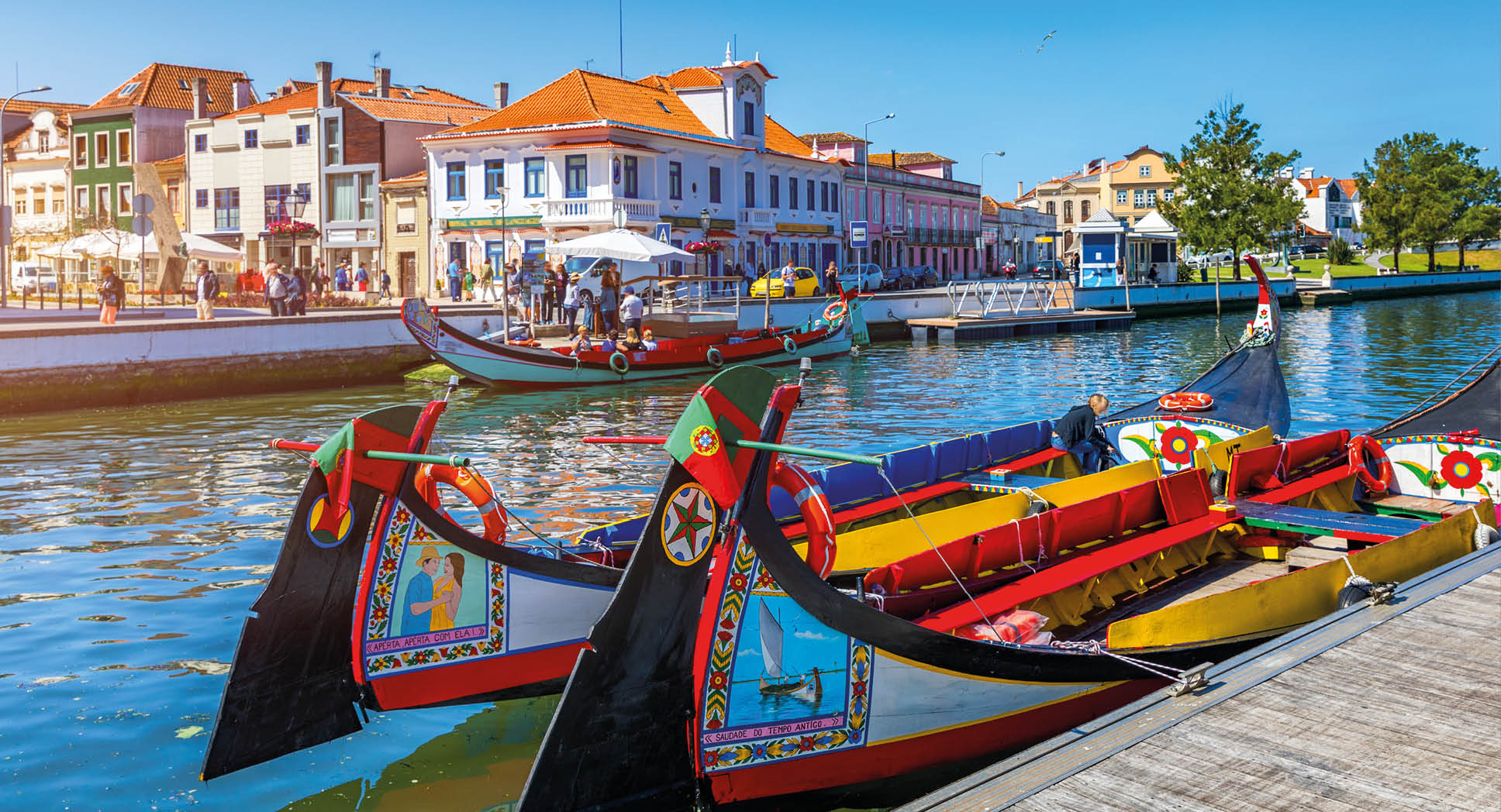 Traditional boats on the canal in Aveiro, Portugal. Colorful Moliceiro boat rides in Aveiro are popular with tourists to enjoy views of the charming canals. Aveiro, Portugal. 