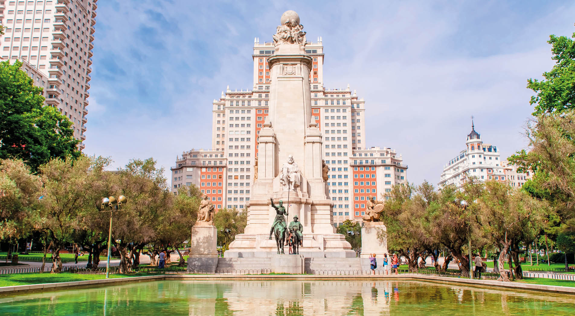 MADRID SPAIN - JUNE 23, 2015: The Cervantes monument, the Tower of Madrid (Torre de Madrid) and the Spain Building (Edificio Espana) on the Square of Spain (Plaza de Espana).
