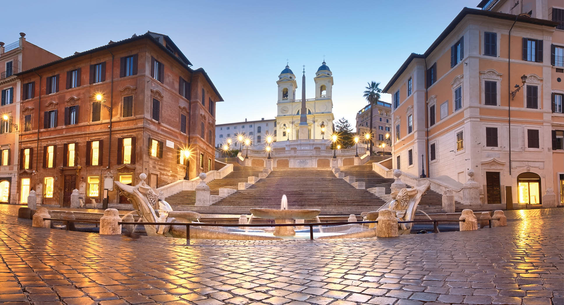Spanish Steps and a boat-shaped fountain on Piazza di Spagna in Rome, Italy. Early morning panoramic shot after rain.
