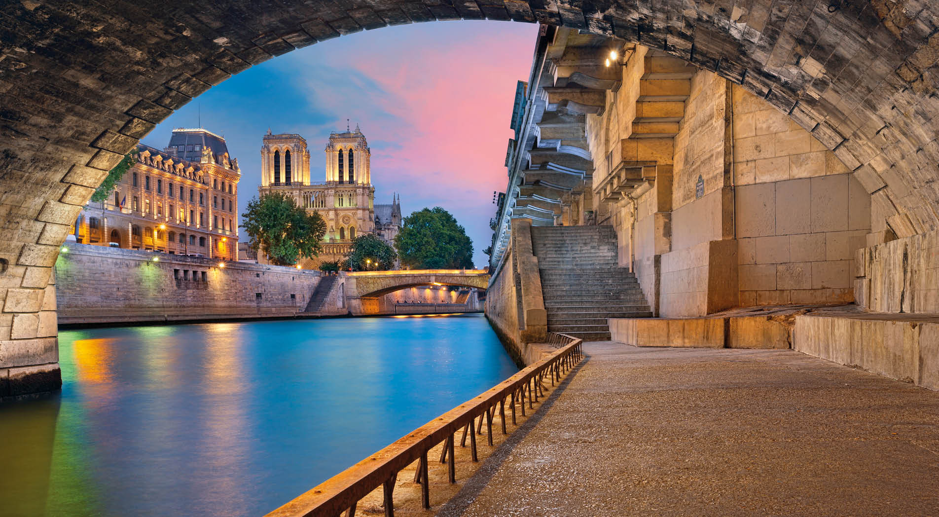 Image of the Notre-Dame de Paris Cathedral and riverside of Seine river in Paris, France.