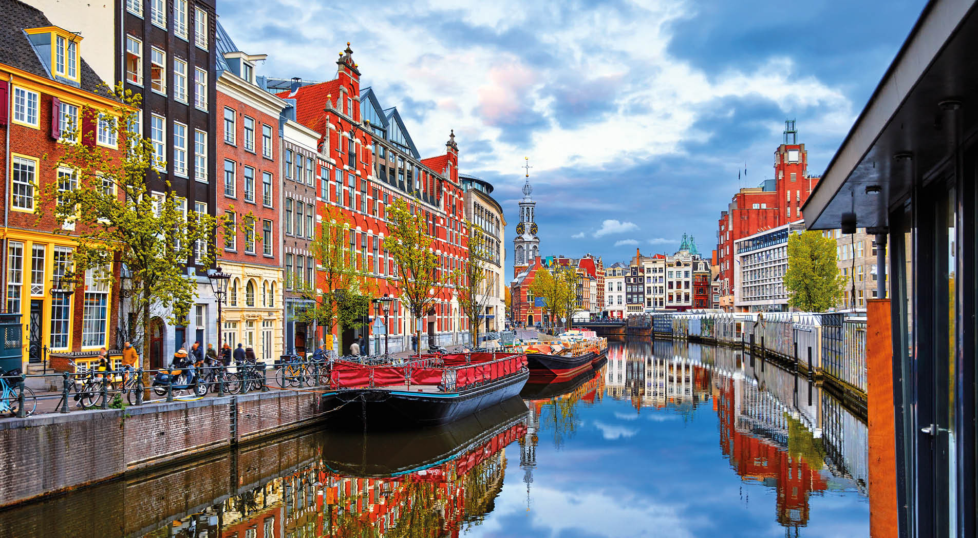 Channel in Amsterdam Netherlands houses river Amstel landmark old european city spring landscape.
