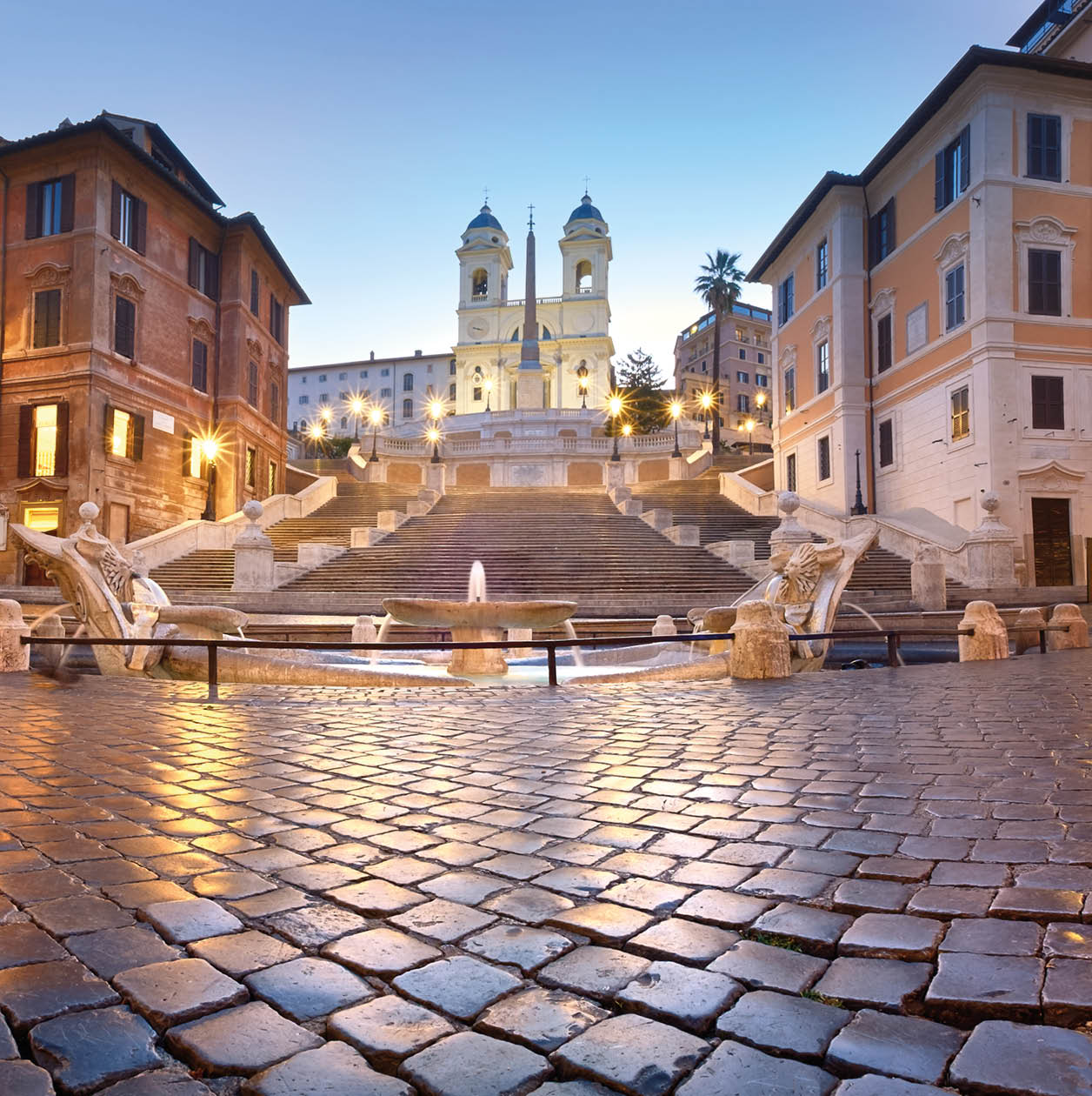 Spanish Steps and a boat-shaped fountain on Piazza di Spagna in Rome, Italy. Early morning panoramic shot after rain.