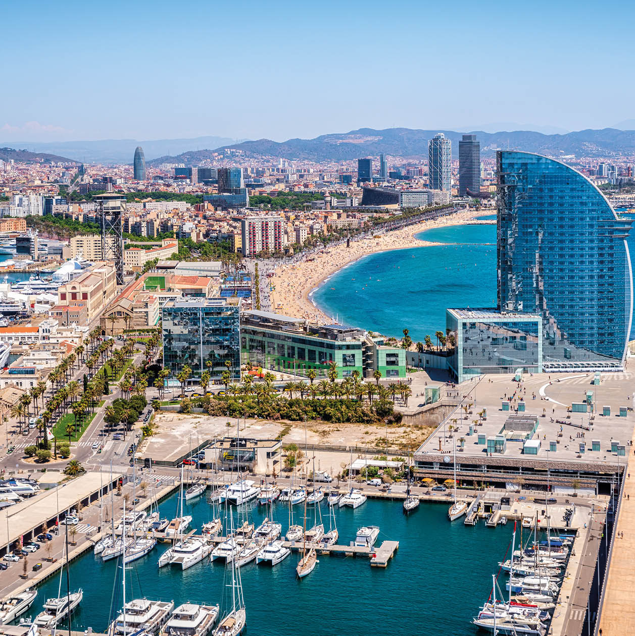 Front of Barcelona from the air with the port vell, the business center and the hotel