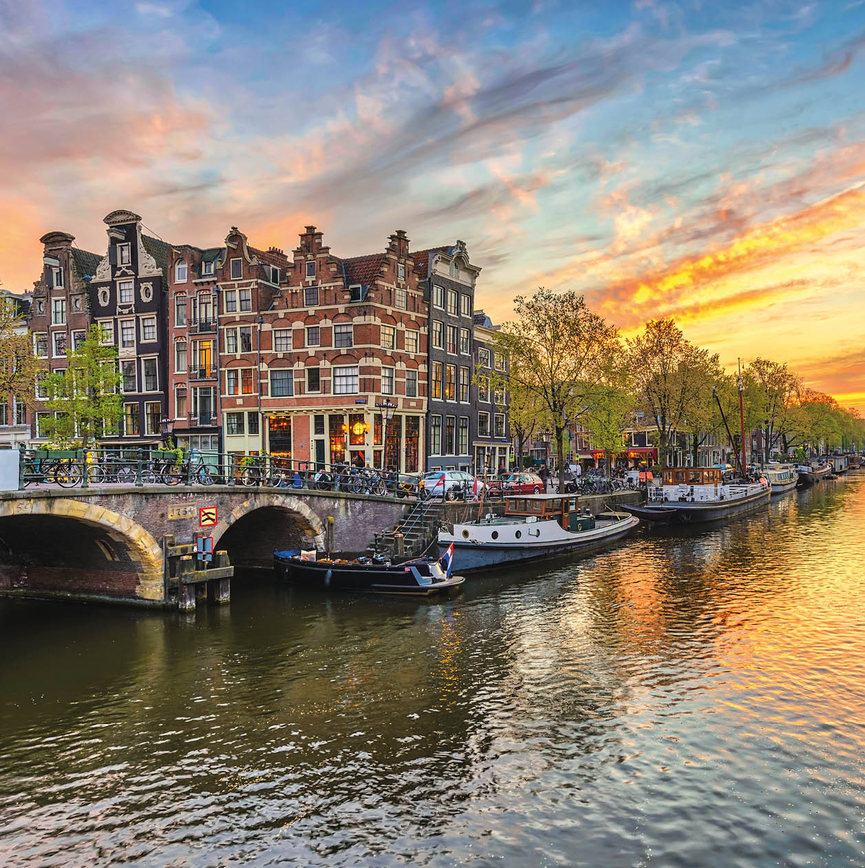 Amsterdam sunset city skyline at canal waterfront, Amsterdam, Netherlands
