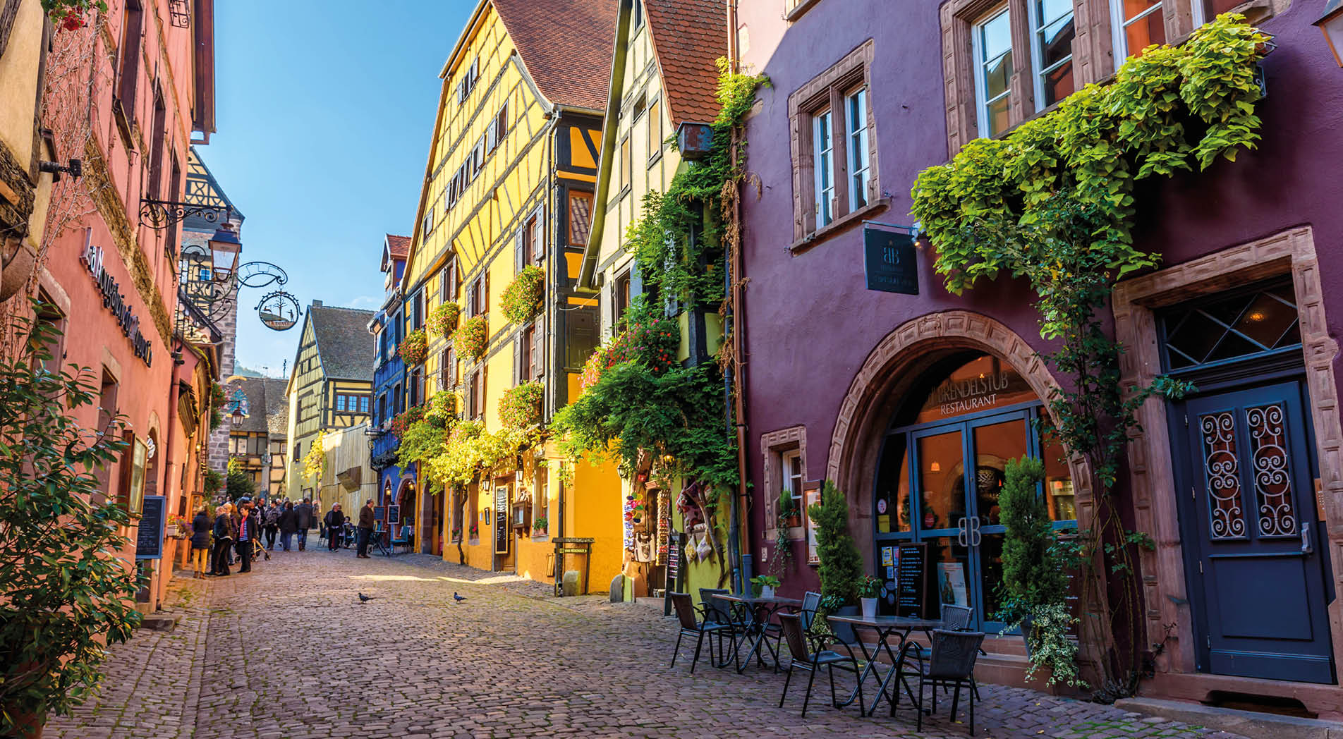 Beautiful village Riquewihr with historic buildings and colorful houses in Alsace of France - Famous vine route - travel destination for vacation