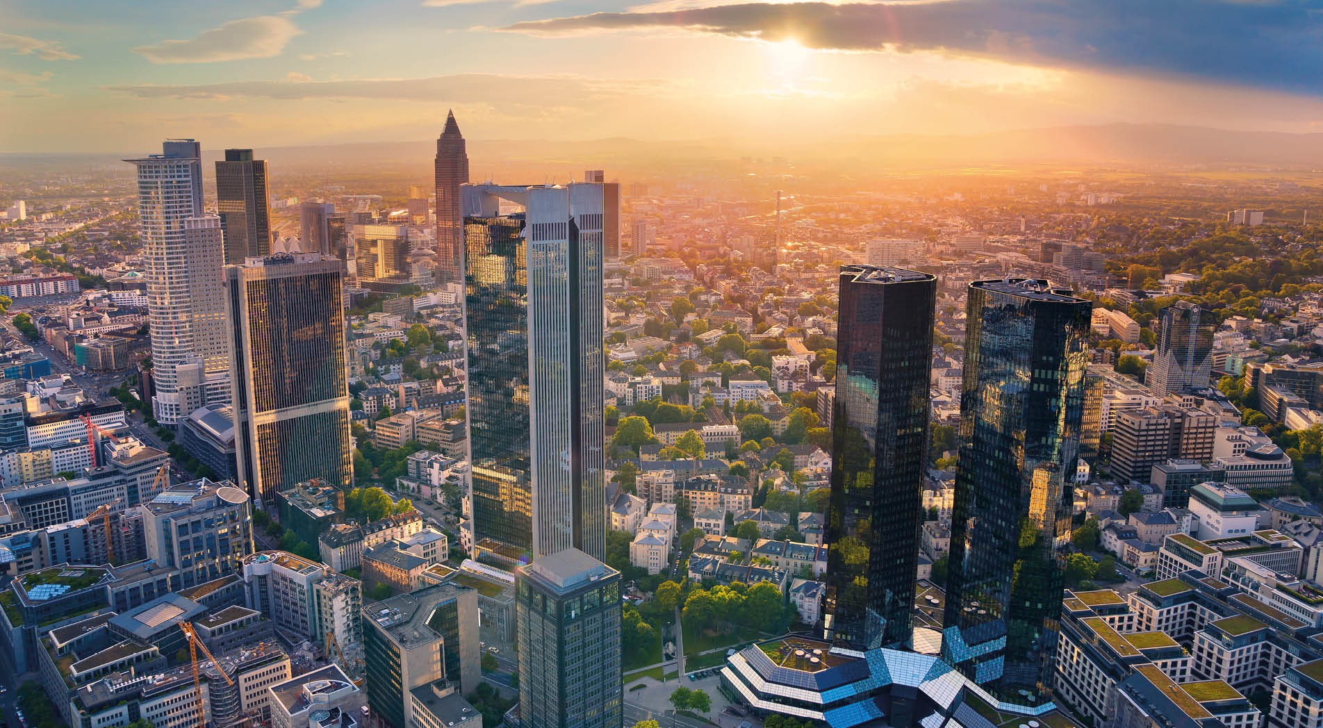 Aerial view of Frankfurt am Main skyline during golden hour.