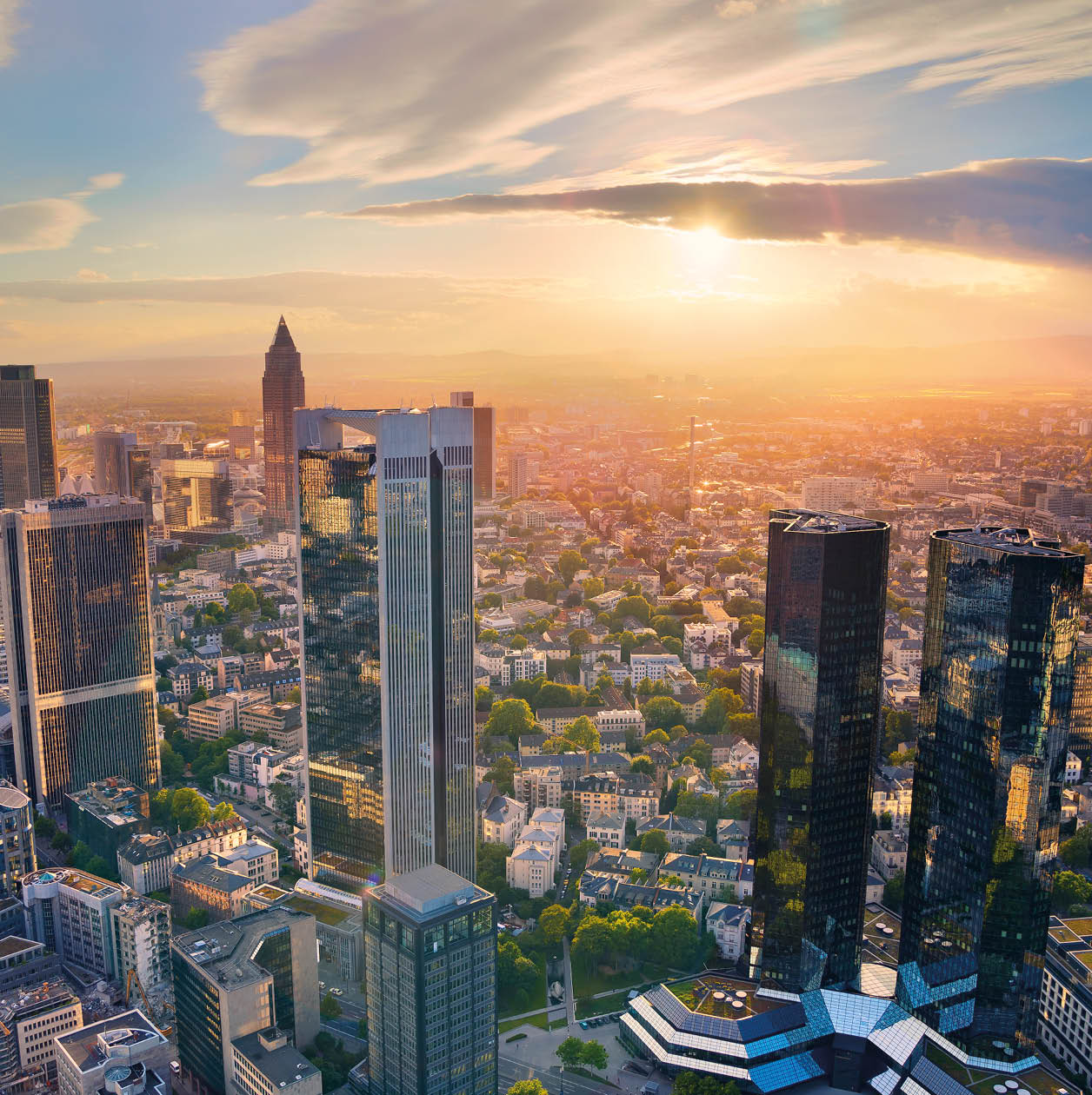 Aerial view of Frankfurt am Main skyline during golden hour.