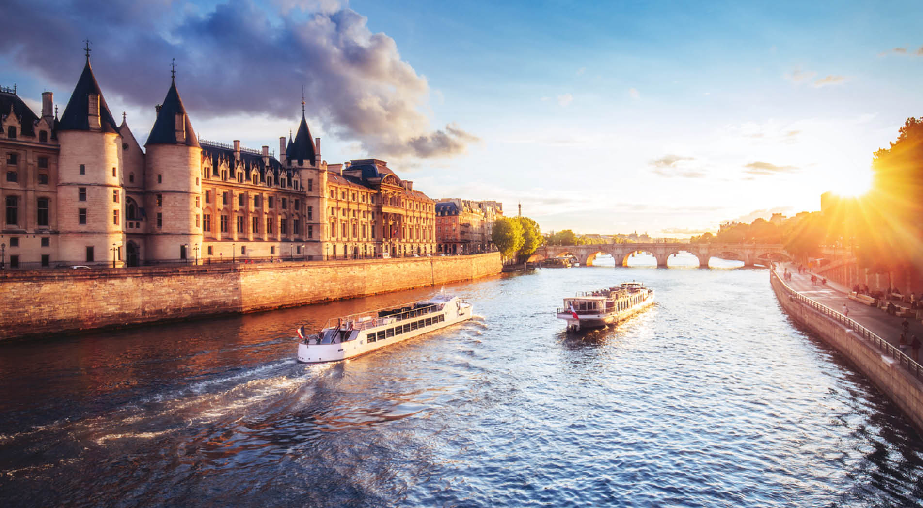 Dramatic sunset over river Seine in Paris, France, with Conciergerie and Pont Neuf. Colourful travel background. Romantic cityscape.