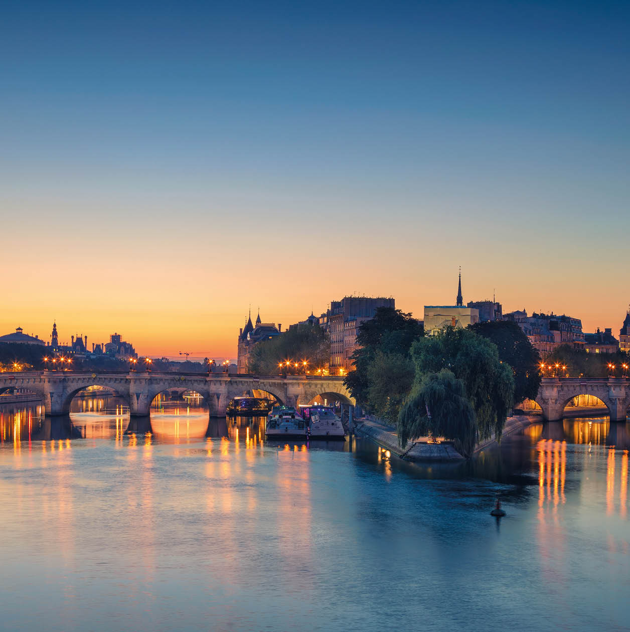 Panoramic image of Paris riverside during sunrise.