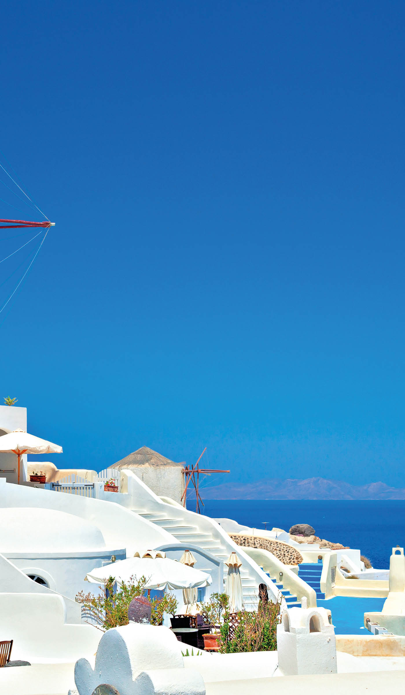 View of carved out of the cliffs houses of Oia, Santorini island, Greece.